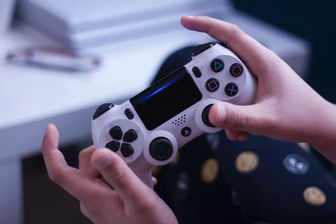 person holding white and black game controller
